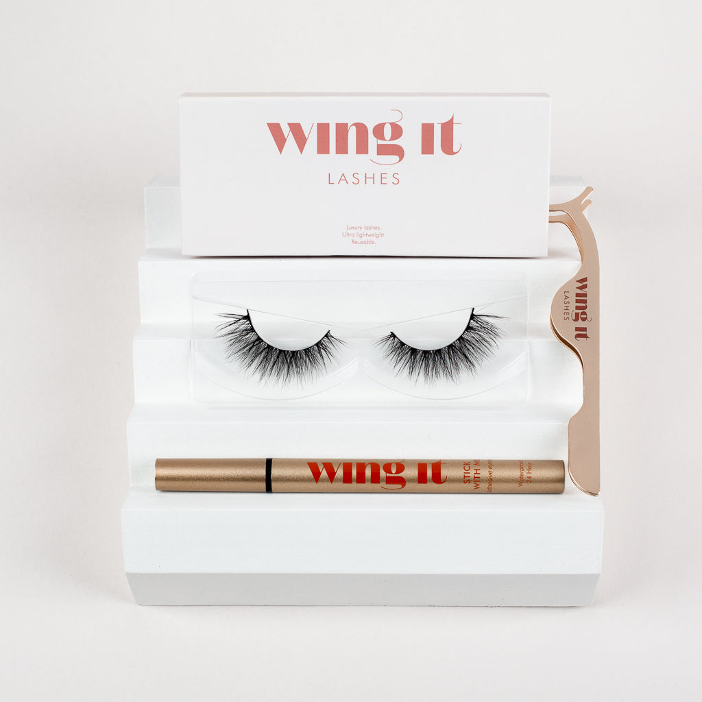 False lash set with pair of silk lashes, gold adhesive eyeliner and lash applicator.