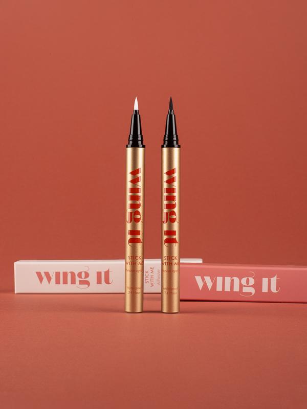 STICK WITH ME adhesive felt tip black and clear eyeliners pack. Waterproof, 24 hour hold. Gold tube, cream wing it cosmetics packaging.